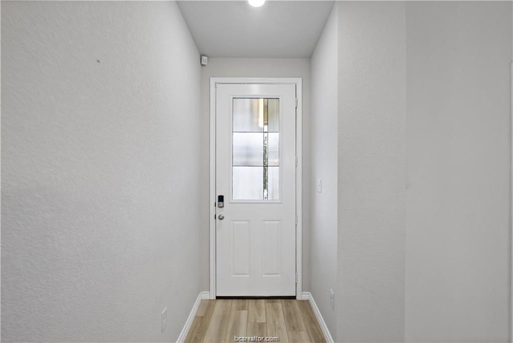 827 Mineral Wells Lane College Station, TX 77845 - Photo 5 of 23 a view of a room with wooden floor and mirror