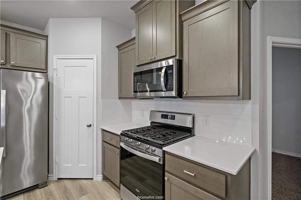 827 Mineral Wells Lane College Station, TX 77845 - Photo 9 of 23 a kitchen with stainless steel appliances a refrigerator stove and microwave