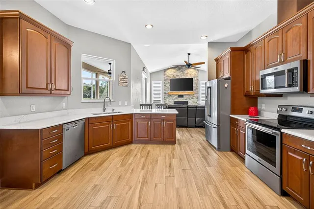 a living room with furniture fireplace and a window