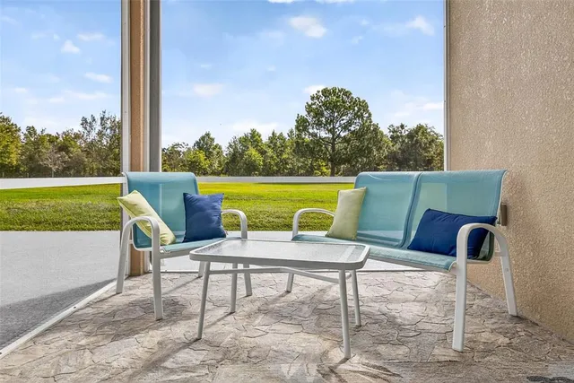 a view of a swimming pool with a patio and a backyard