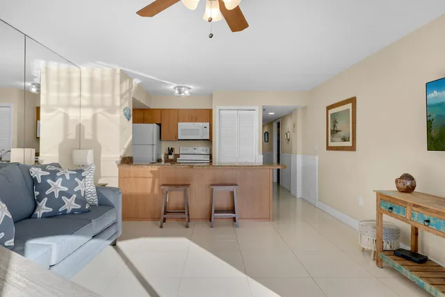 a living room with furniture and view of kitchen