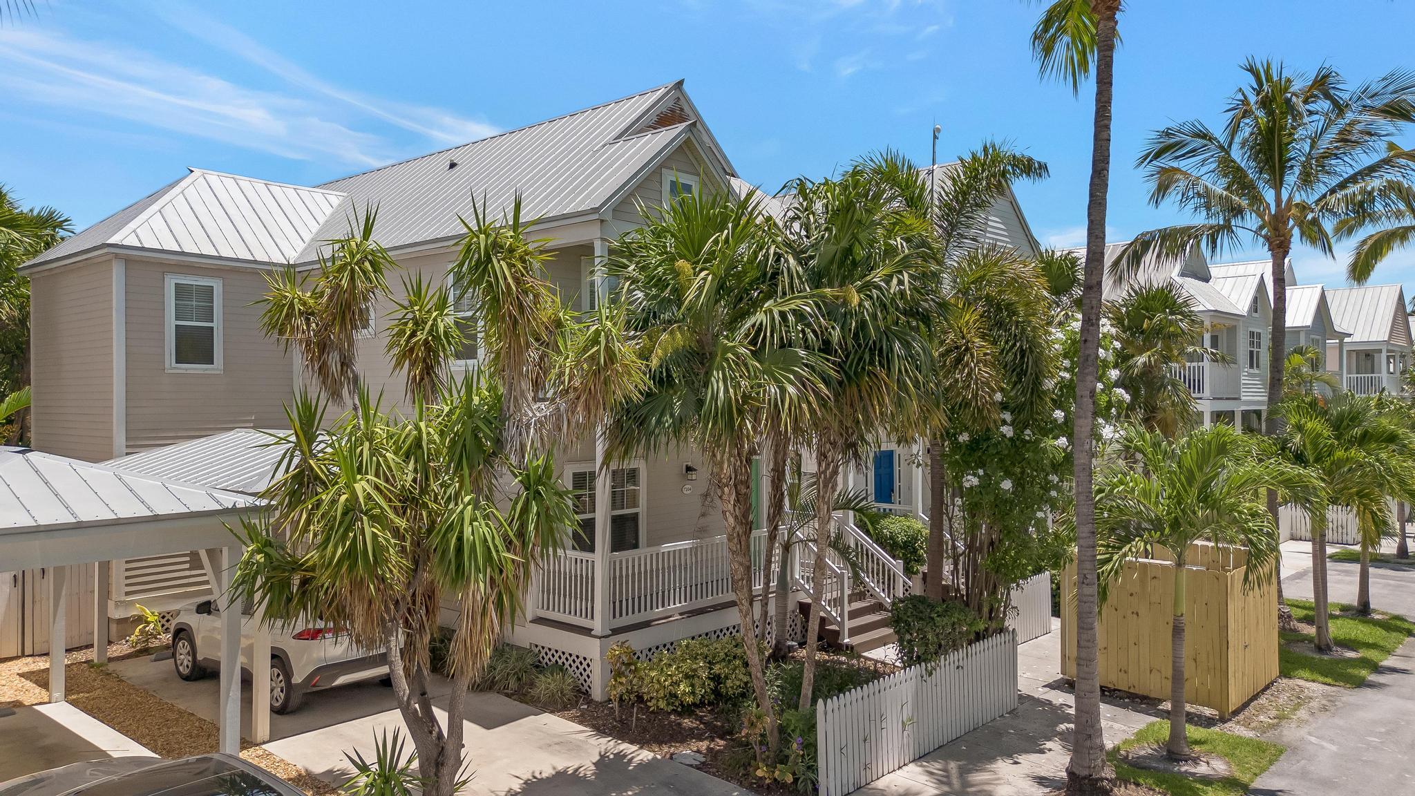7204 Simran Lane Marathon, FL 33050 - Photo 1 of 47 a view of a house with a palm tree and a yard