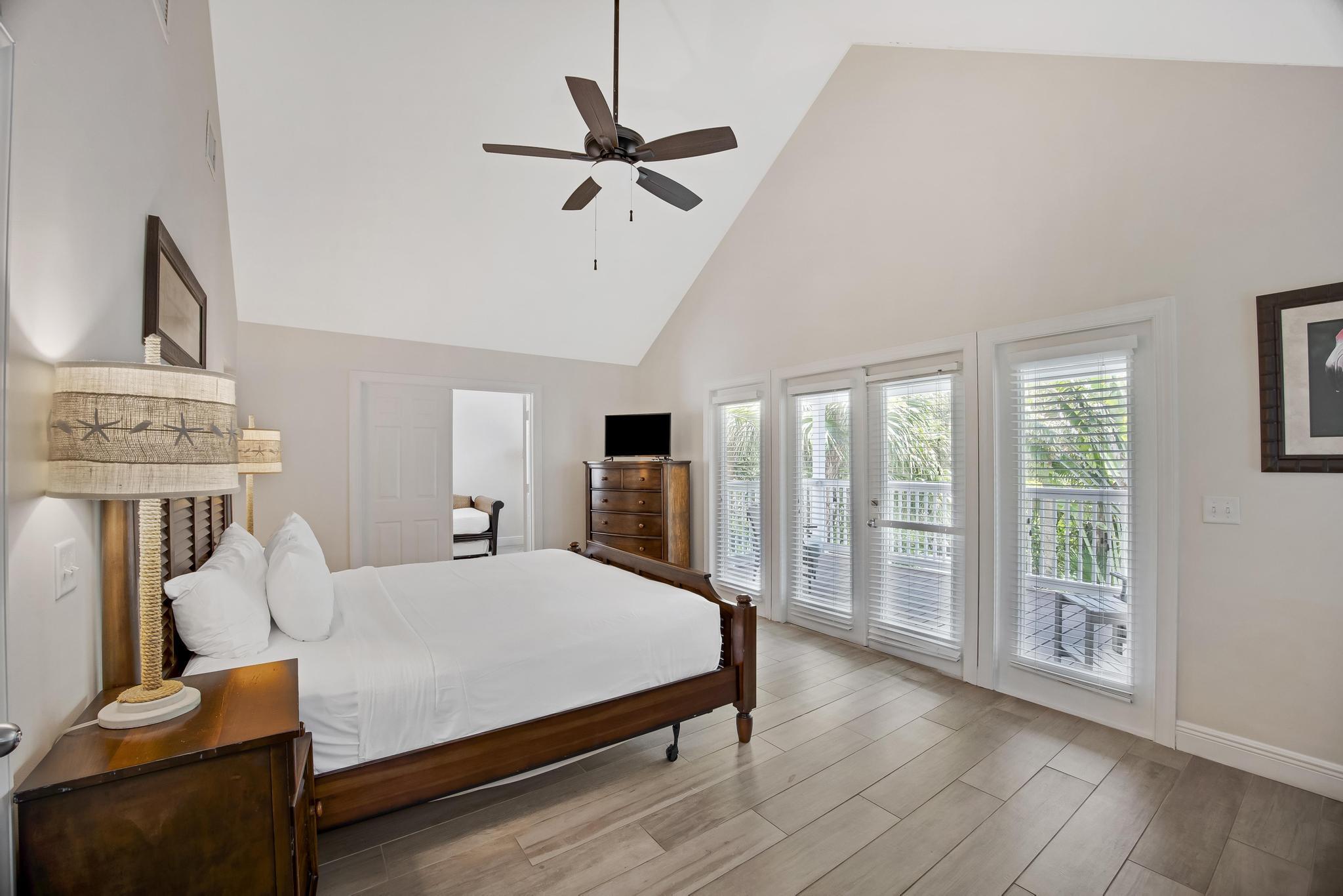 7204 Simran Lane Marathon, FL 33050 - Photo 19 of 47 a bedroom with a large bed and a tv