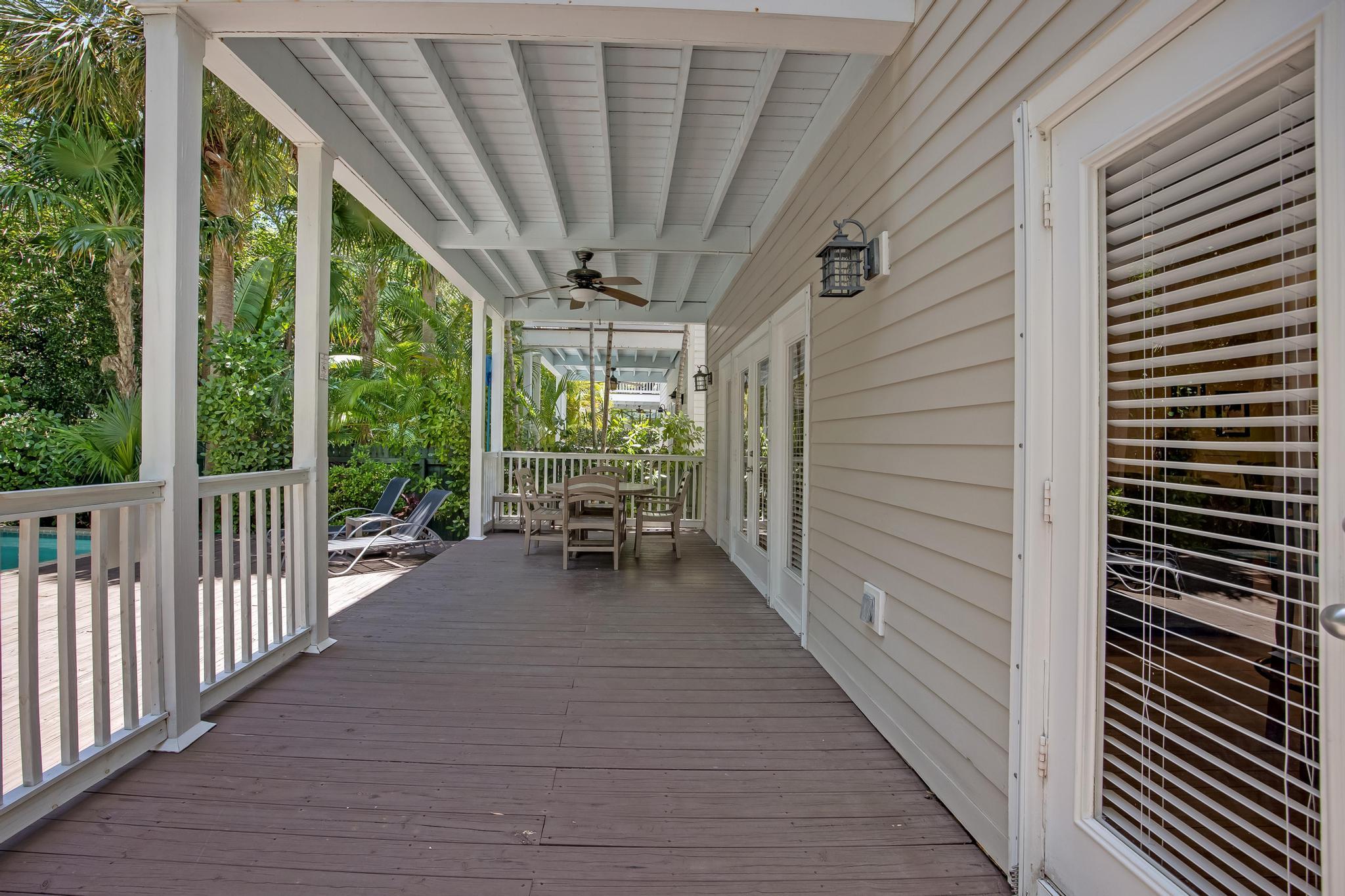 7204 Simran Lane Marathon, FL 33050 - Photo 20 of 47 a view of a balcony with chairs and wooden fence