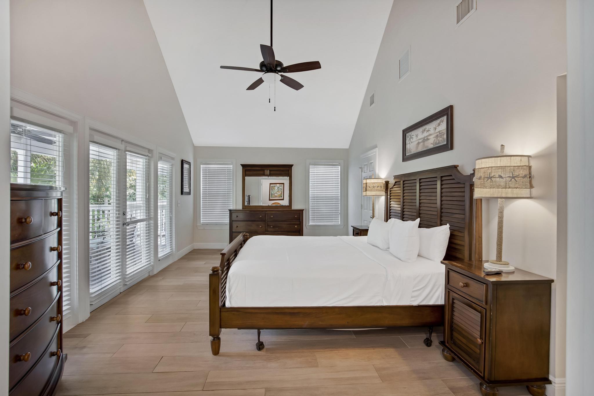 7204 Simran Lane Marathon, FL 33050 - Photo 22 of 47 a bedroom with a bed a couch and dresser