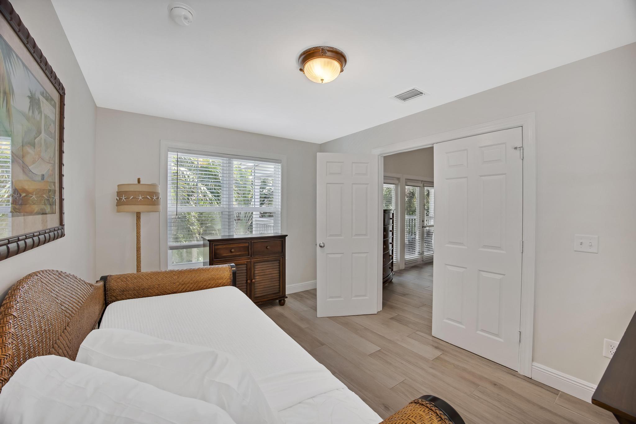 7204 Simran Lane Marathon, FL 33050 - Photo 24 of 47 a bedroom with furniture and a window