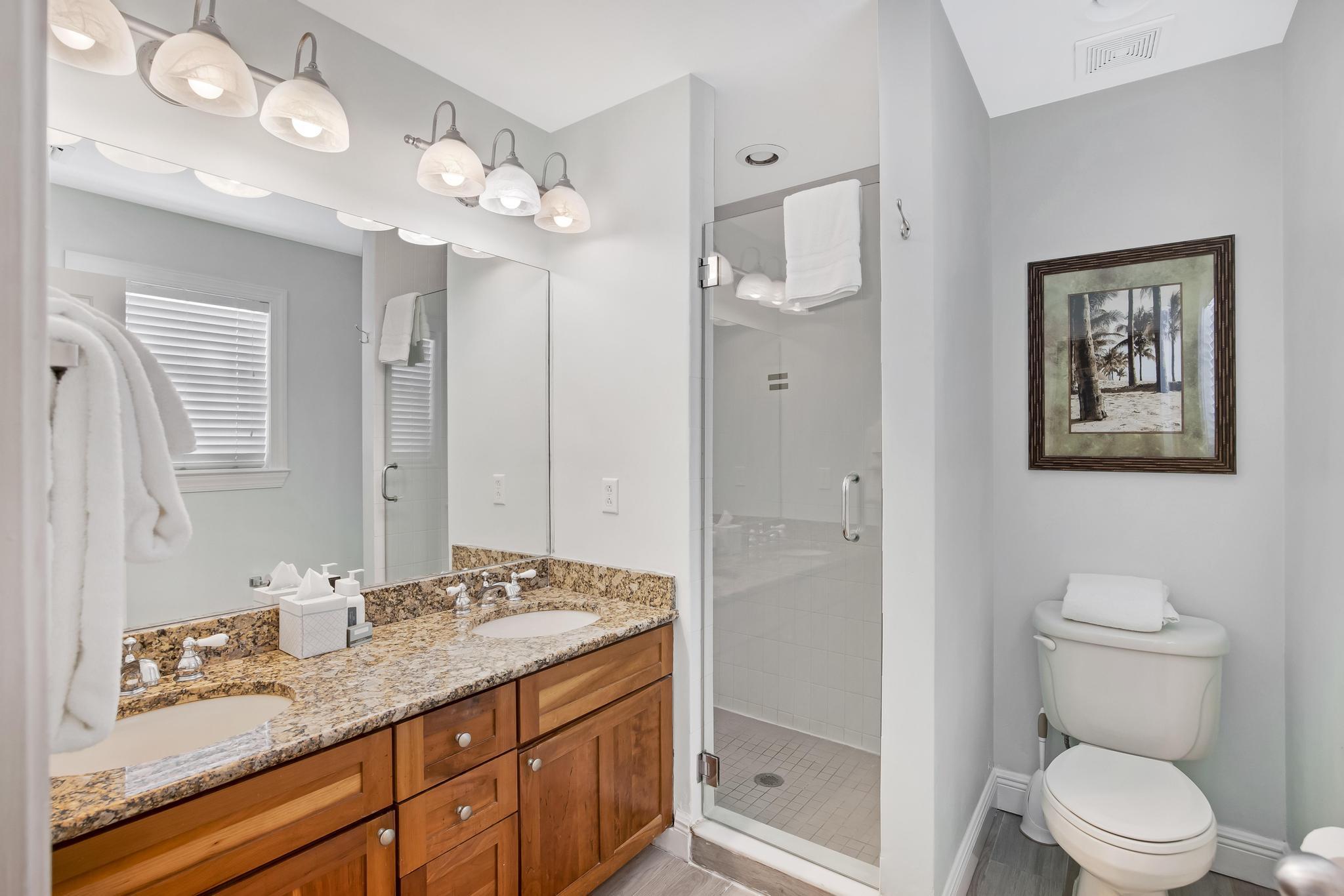 7204 Simran Lane Marathon, FL 33050 - Photo 26 of 47 a bathroom with a granite countertop sink a toilet and a mirror