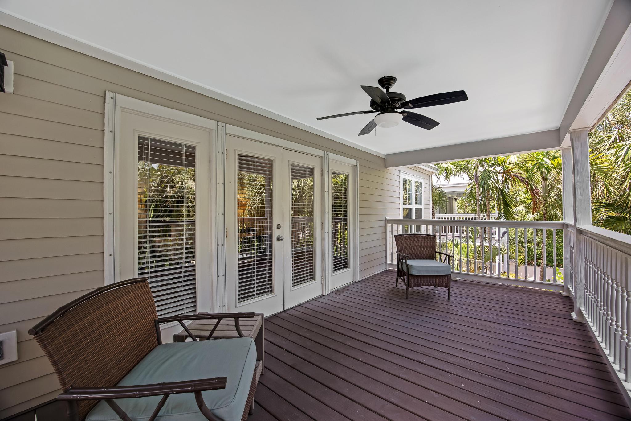 7204 Simran Lane Marathon, FL 33050 - Photo 30 of 47 a balcony with wooden floor and outdoor seating