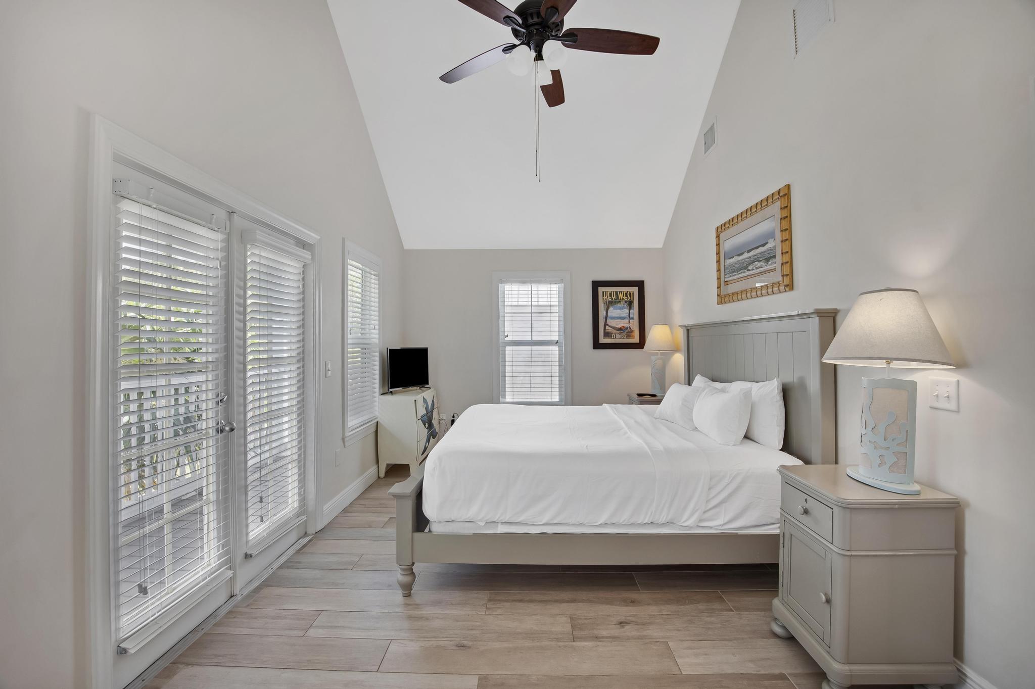 7204 Simran Lane Marathon, FL 33050 - Photo 34 of 47 a bedroom with a large bed and a chandelier fan