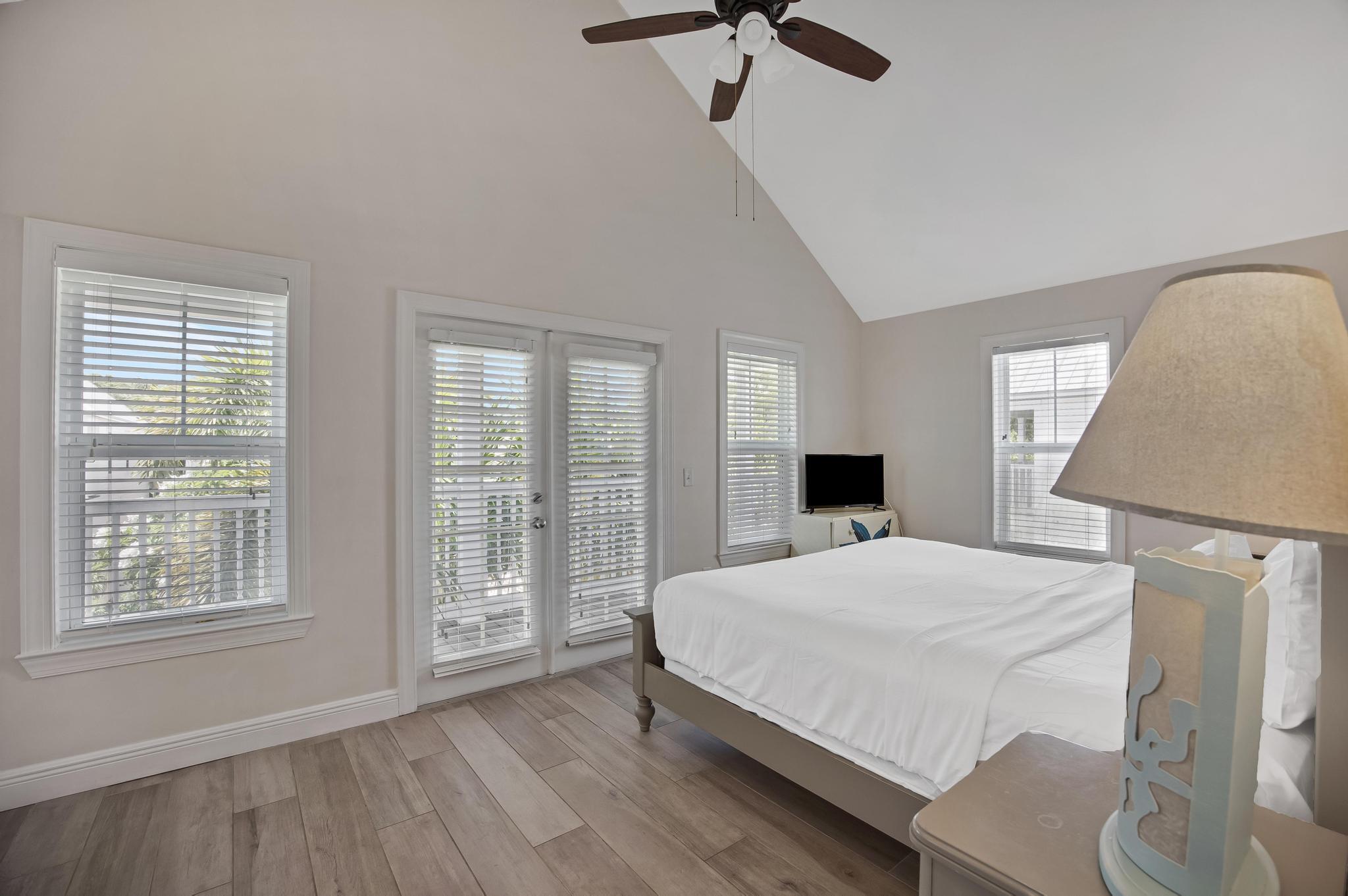 7204 Simran Lane Marathon, FL 33050 - Photo 35 of 47 a bedroom with a large bed and a chair