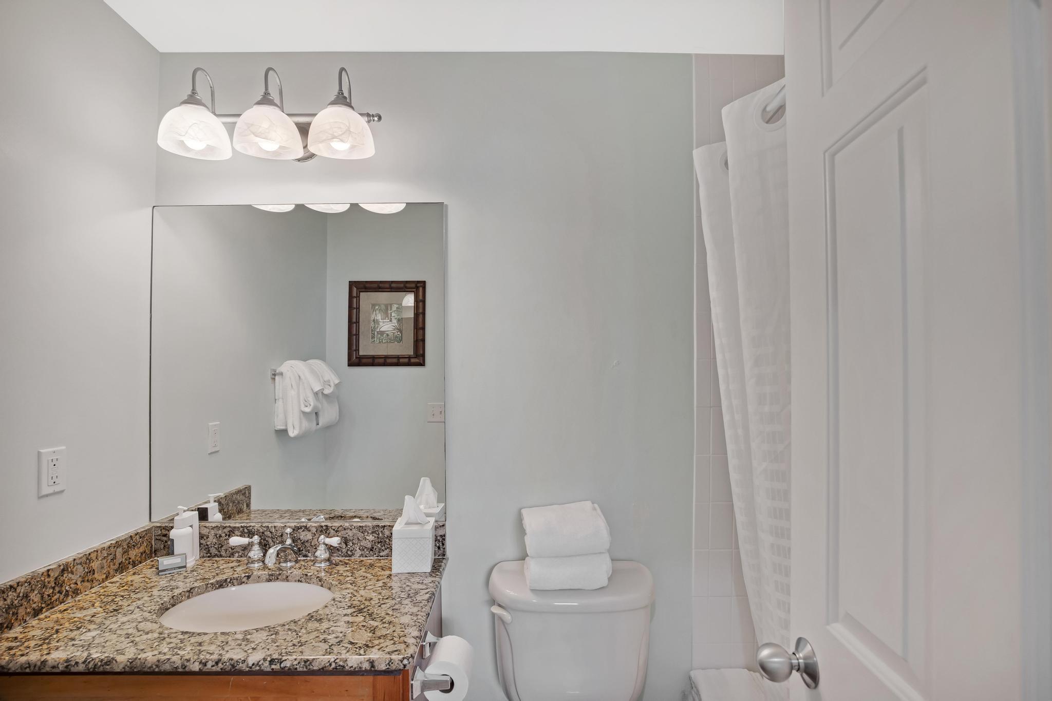 7204 Simran Lane Marathon, FL 33050 - Photo 36 of 47 a bathroom with a granite countertop sink a toilet and a mirror