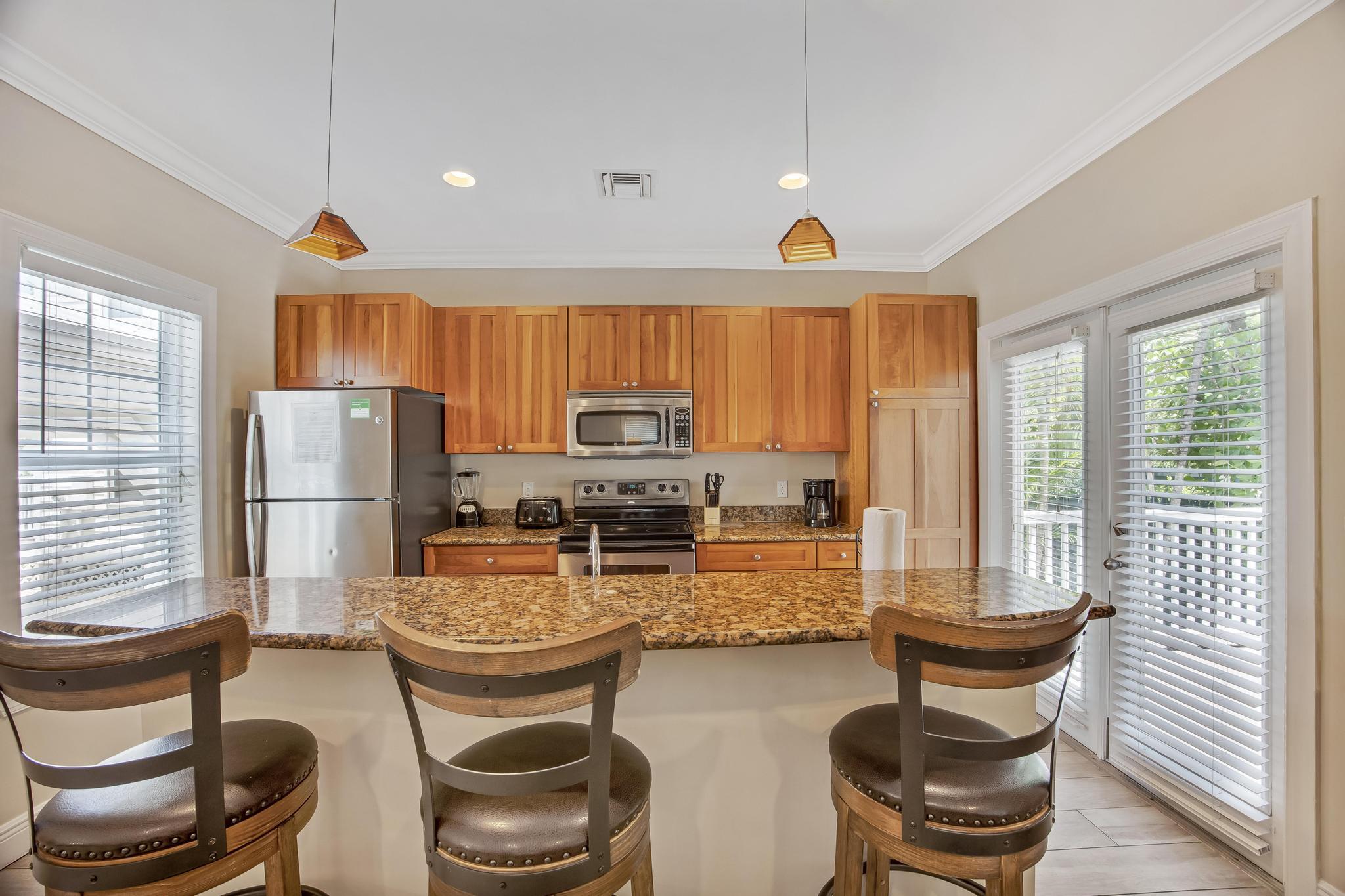 7204 Simran Lane Marathon, FL 33050 - Photo 4 of 47 a kitchen with sink refrigerator dining table and chairs