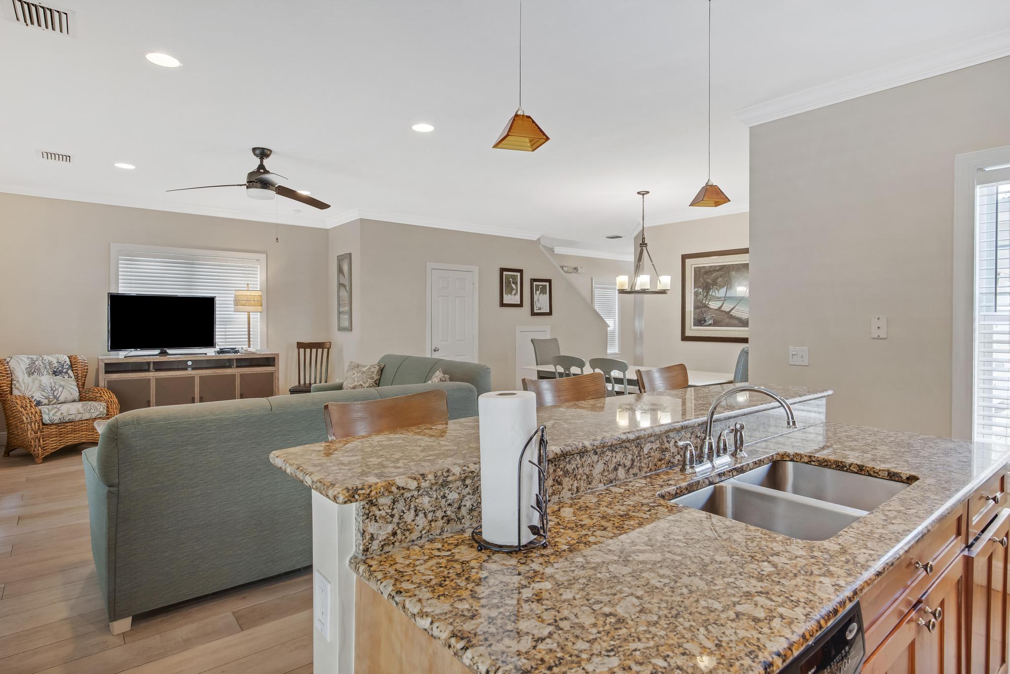 7204 Simran Lane Marathon, FL 33050 - Photo 7 of 47 a kitchen with granite countertop a sink a counter top space and living room view