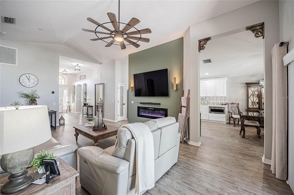 2524 Siena Way Valrico, FL 33596 - Photo 11 of 38 a living room with furniture a flat screen tv and kitchen view