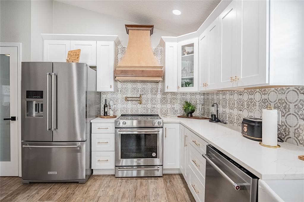 2524 Siena Way Valrico, FL 33596 - Photo 16 of 38 a kitchen with a white stove top oven and refrigerator