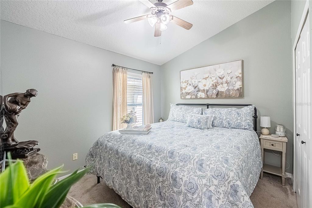 2524 Siena Way Valrico, FL 33596 - Photo 26 of 38 a bedroom with a bed and a chandelier