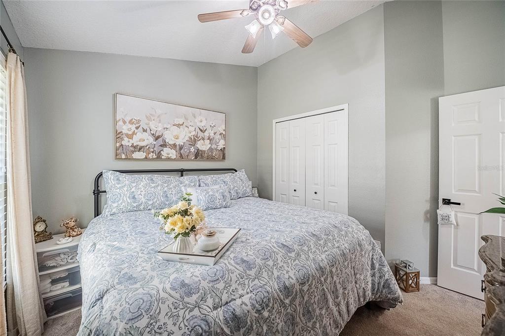 2524 Siena Way Valrico, FL 33596 - Photo 27 of 38 a bedroom with a bed and a chandelier