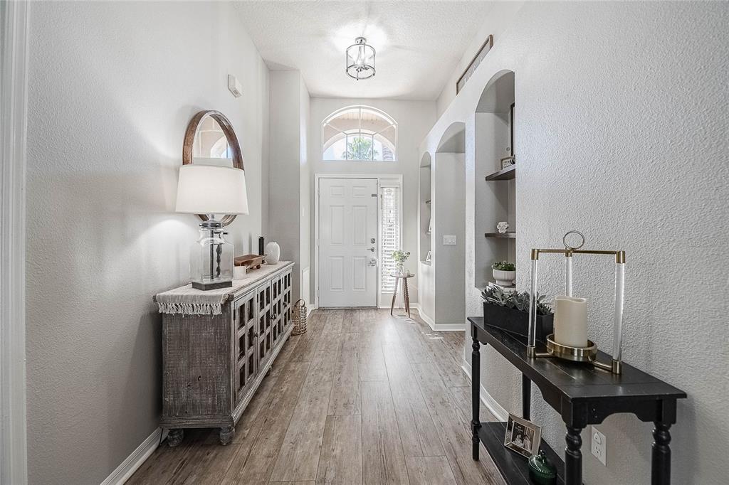 2524 Siena Way Valrico, FL 33596 - Photo 3 of 38 a view of a hallway with entryway wooden floor and front door