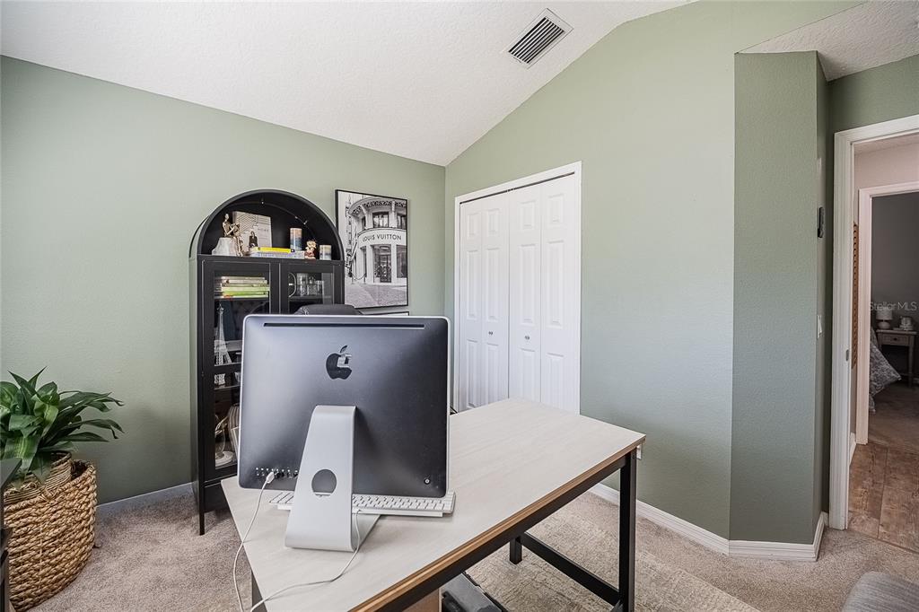 2524 Siena Way Valrico, FL 33596 - Photo 31 of 38 a living room with a table and potted plants