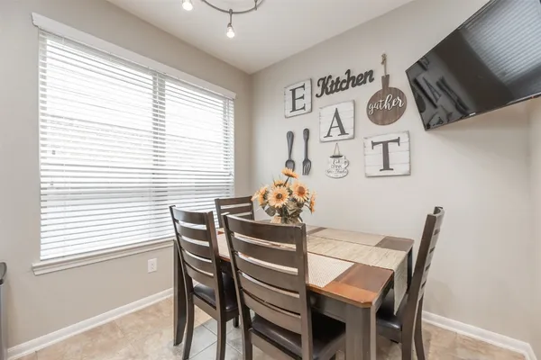 a dining room with furniture and window