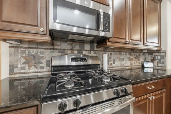 a stove top oven sitting inside of a kitchen
