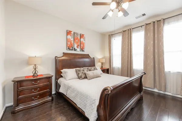a bedroom with a bed and a chandelier