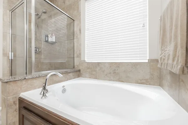 a white bath tub sitting in a bathroom next to a sink