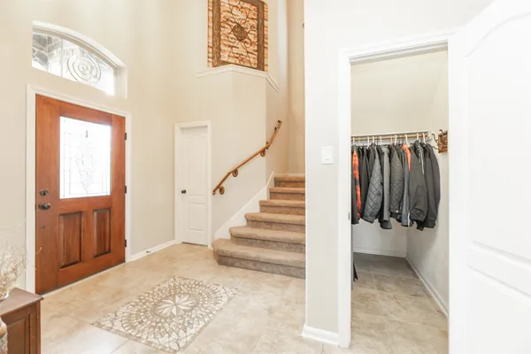 a view of a hallway with wooden floor and entryway