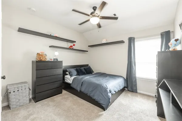 a bedroom with a bed and a dresser
