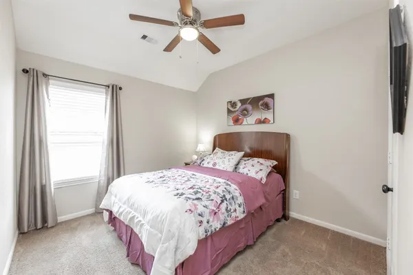 a bedroom with a bed and a window