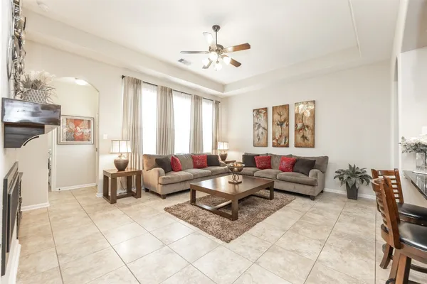 a living room with furniture and a chandelier