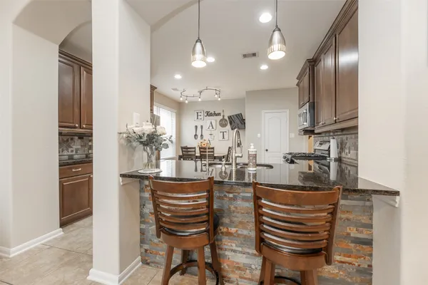 a kitchen with refrigerator and cabinets