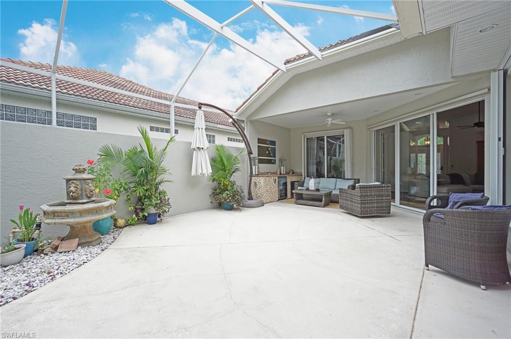 3188 Sundance Circle Naples, FL 34109 - Photo 12 of 39 a view of a patio with couches and potted plants