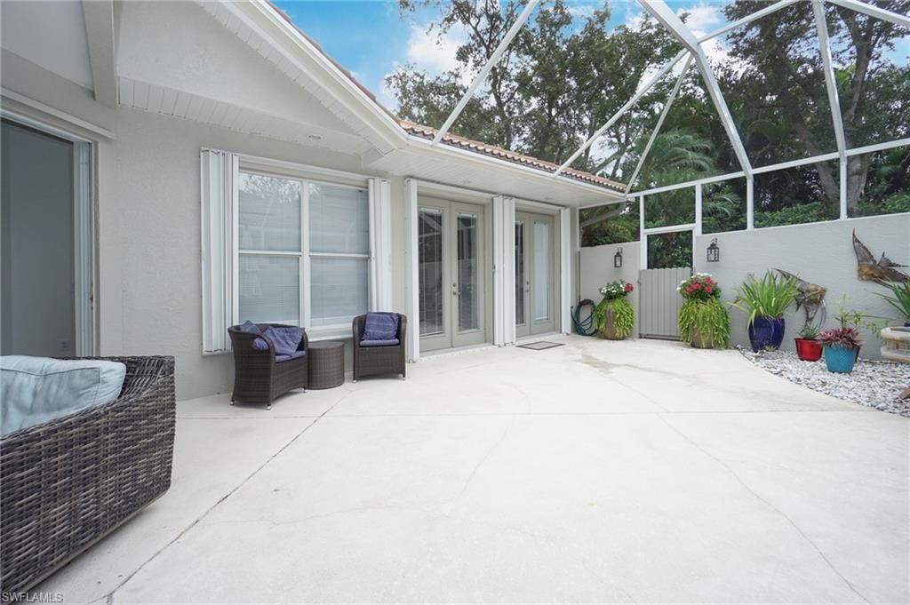 3188 Sundance Circle Naples, FL 34109 - Photo 14 of 39 a view of a patio with couches table and chairs and potted plants