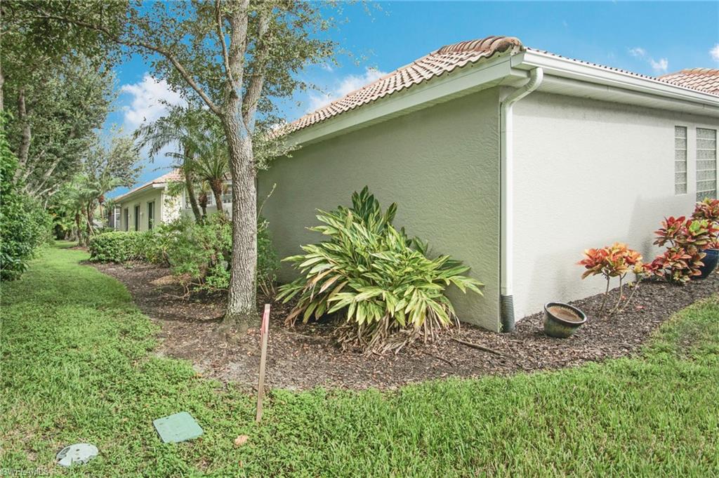 3188 Sundance Circle Naples, FL 34109 - Photo 30 of 39 a backyard of a house with lots of green space