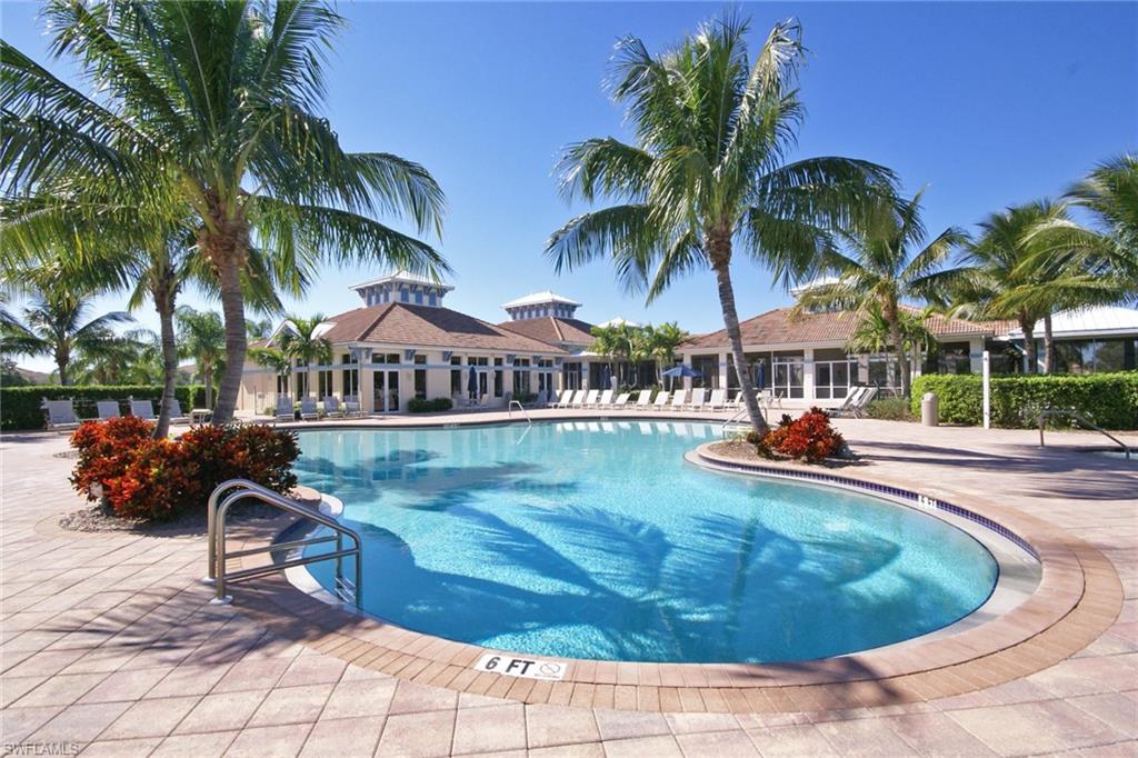 3188 Sundance Circle Naples, FL 34109 - Photo 35 of 39 a view of a swimming pool with lounge chair