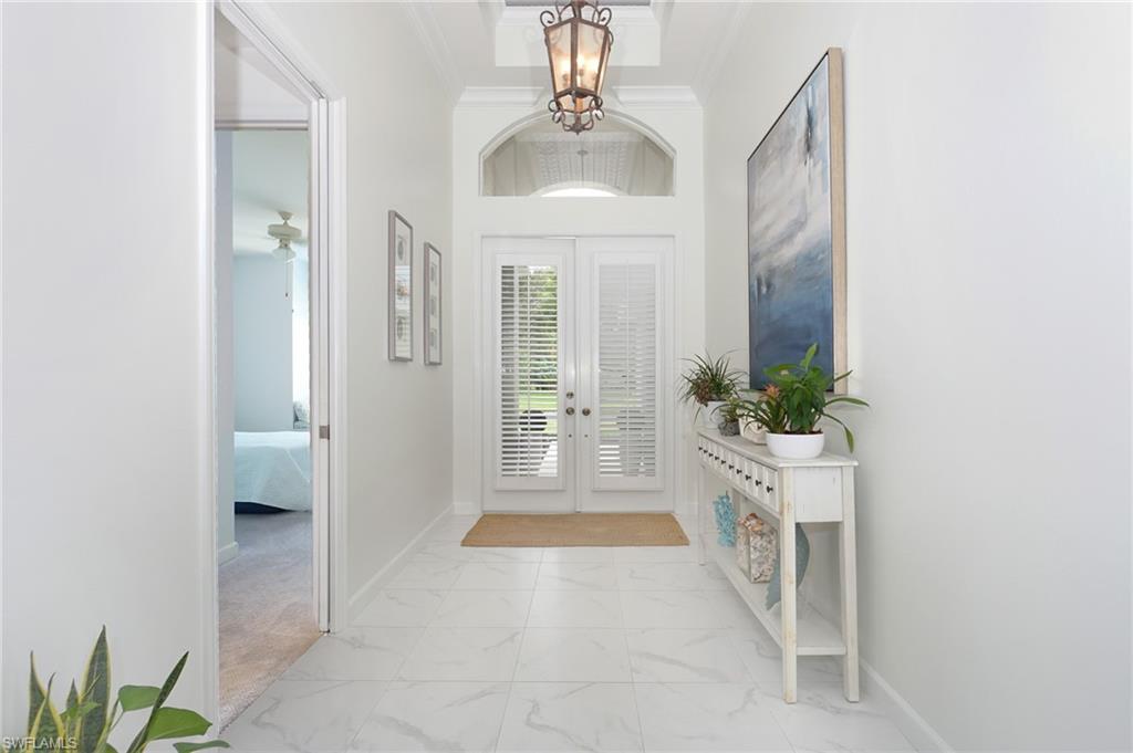 3188 Sundance Circle Naples, FL 34109 - Photo 4 of 39 a view of a hallway with a potted plant
