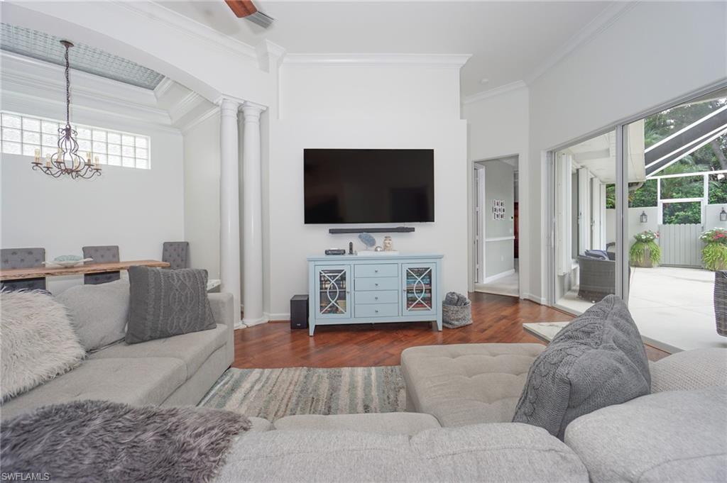 3188 Sundance Circle Naples, FL 34109 - Photo 6 of 39 a living room with furniture and a flat screen tv