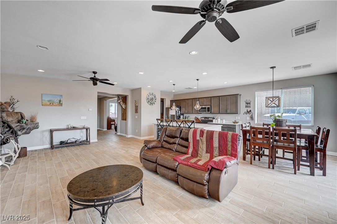 4045 River Heights Lane Logandale, NV 89021 - Photo 12 of 38 Living room featuring a ceiling fan, light wood fi