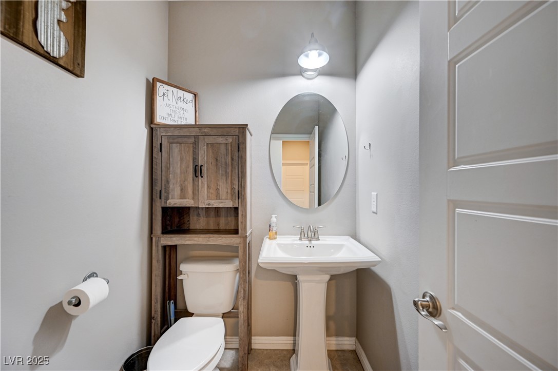 4045 River Heights Lane Logandale, NV 89021 - Photo 17 of 38 Half bath featuring toilet and tile patterned floo