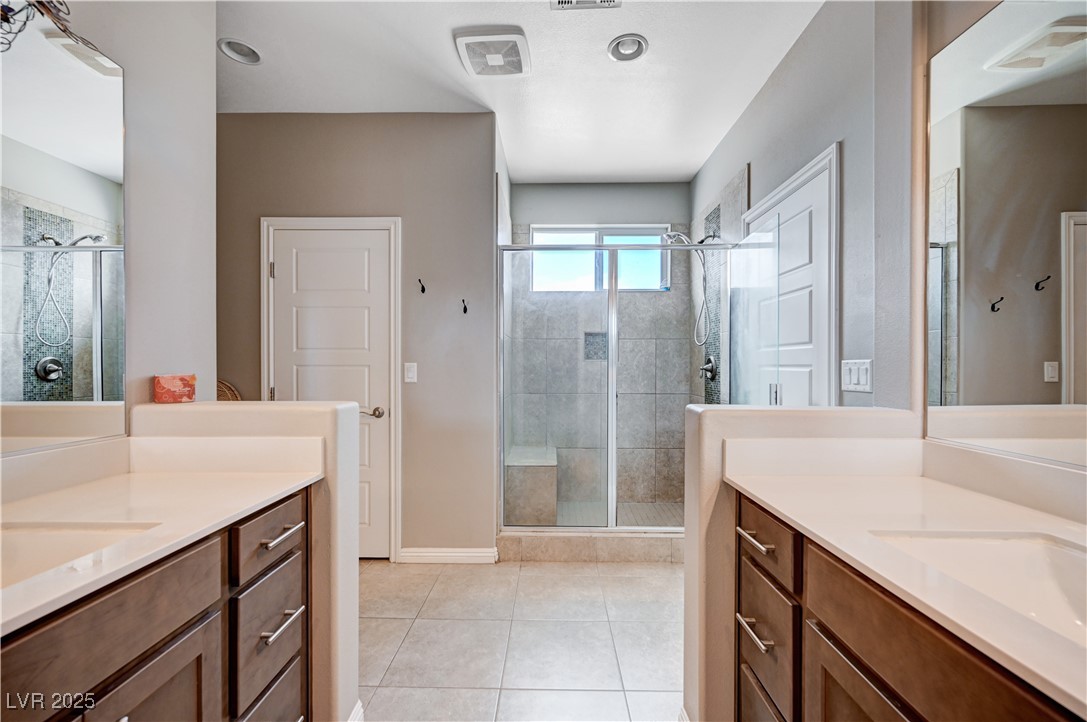 4045 River Heights Lane Logandale, NV 89021 - Photo 27 of 38 Bathroom with two vanities, a shower stall, and ti