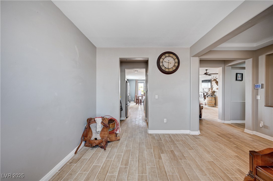4045 River Heights Lane Logandale, NV 89021 - Photo 3 of 38 Sitting room with a ceiling fan and light wood-typ