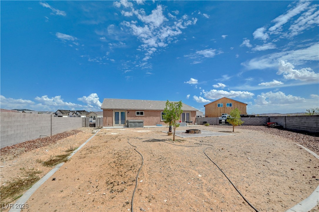 4045 River Heights Lane Logandale, NV 89021 - Photo 31 of 38 Rear view of house featuring a patio, a fenced bac