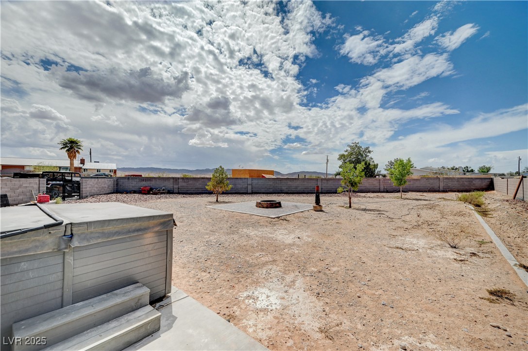 4045 River Heights Lane Logandale, NV 89021 - Photo 32 of 38 Fenced backyard featuring a hot tub and an outdoor