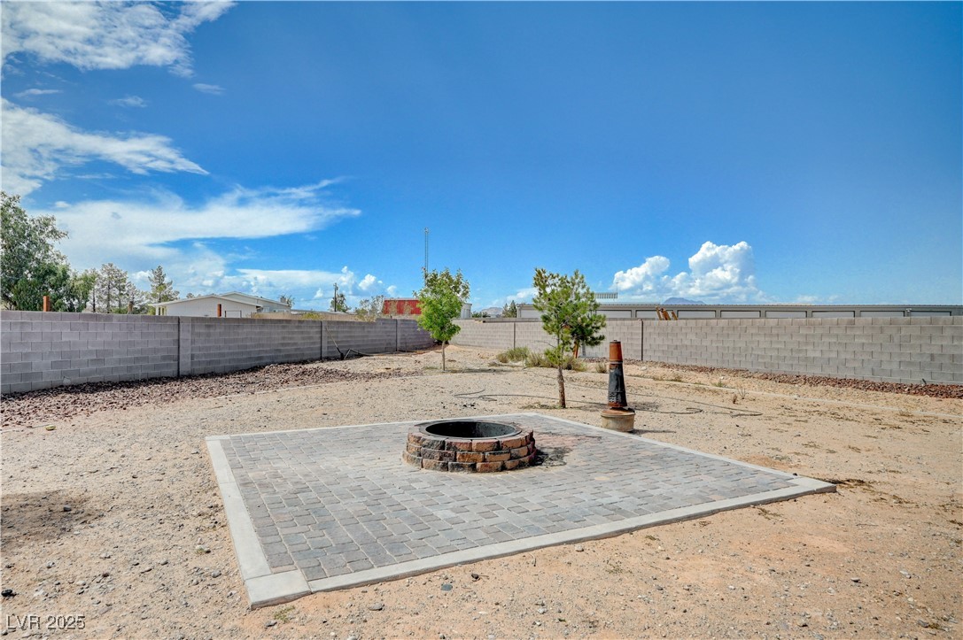 4045 River Heights Lane Logandale, NV 89021 - Photo 33 of 38 Fenced backyard with a fire pit and a patio area