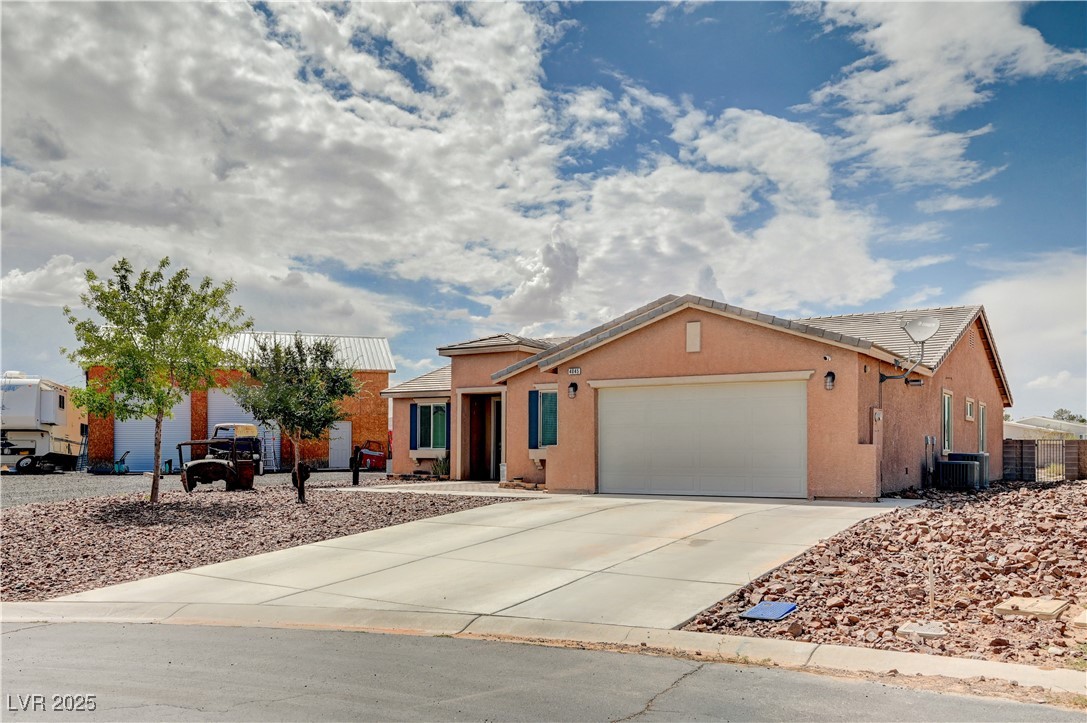 4045 River Heights Lane Logandale, NV 89021 - Photo 34 of 38 Ranch-style home with a garage, concrete driveway,