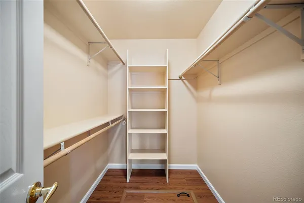 a view of walk in closet with empty racks