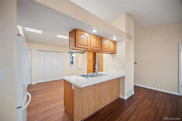a view of kitchen island with wooden floor and window
