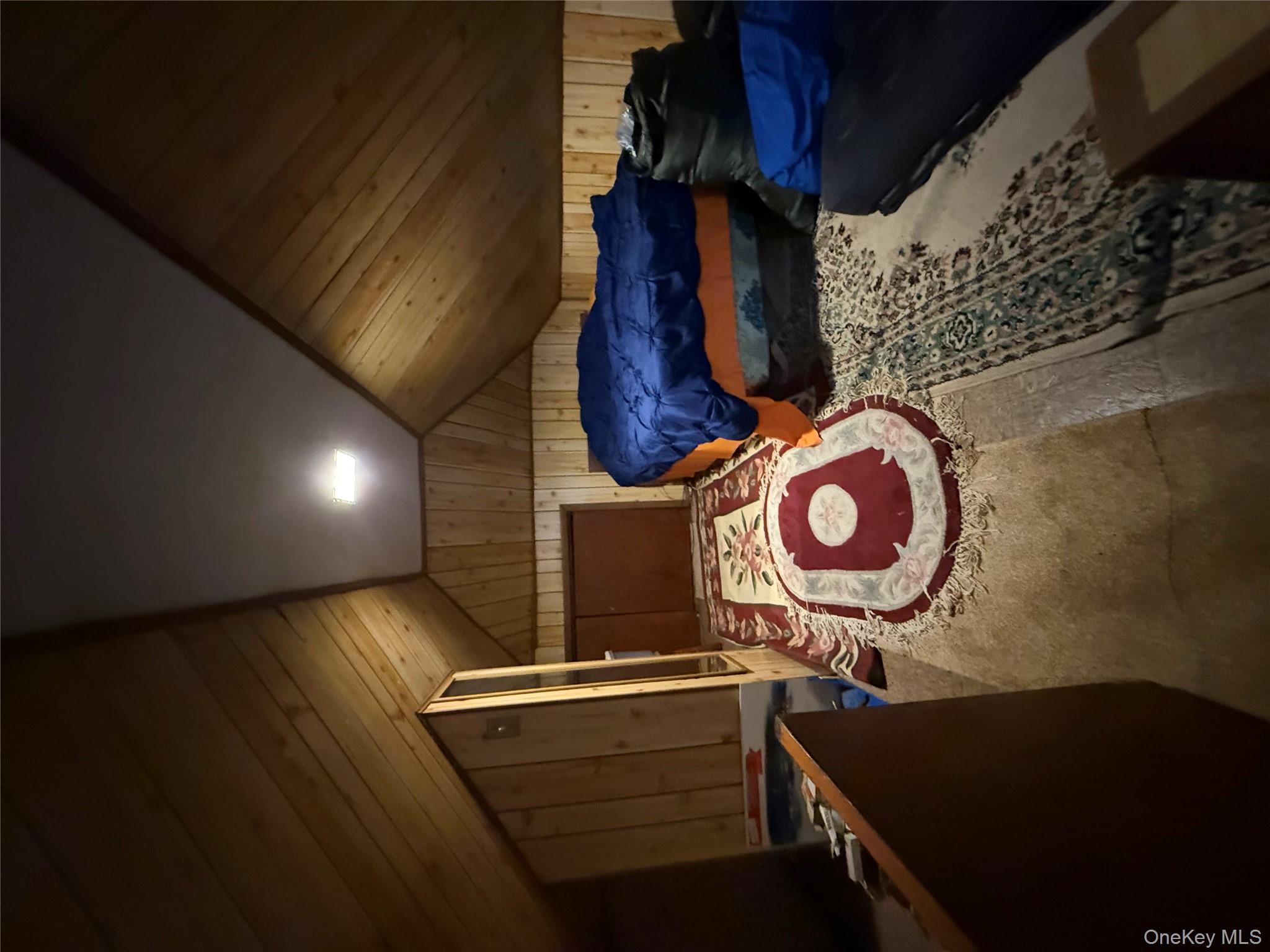 104-25 126th Street Queens, NY 11419 - Photo 12 of 22 Bedroom featuring lofted ceiling and wood walls