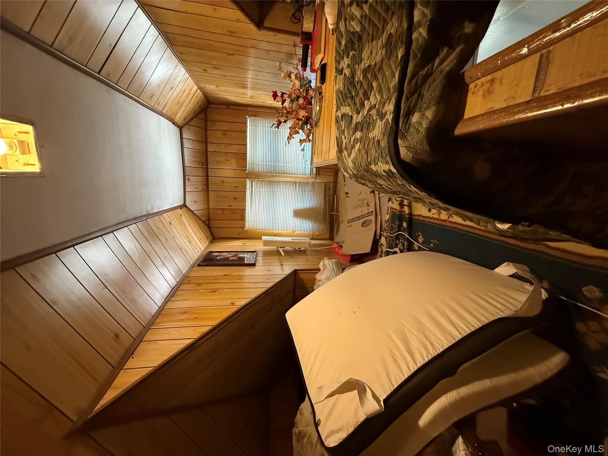 104-25 126th Street Queens, NY 11419 - Photo 13 of 22 Bedroom with wooden walls, vaulted ceiling, and wood ceiling